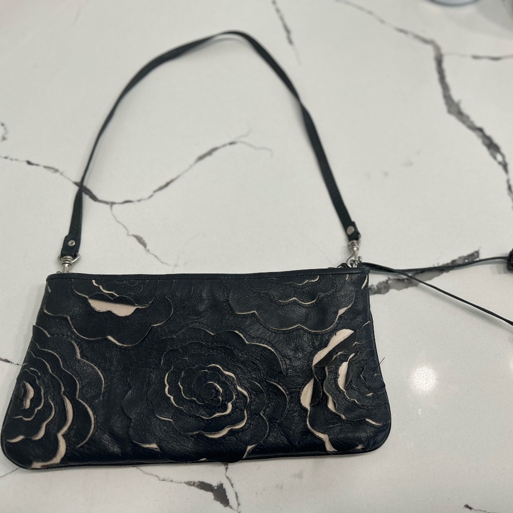 A small navy blue clutch purse